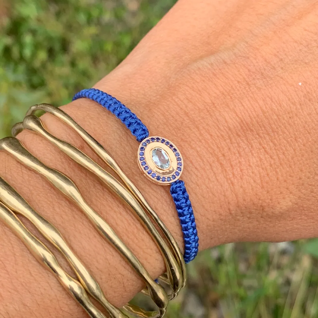 Aquamarine and Blue Sapphire braided bracelet in 10k yellow gold.