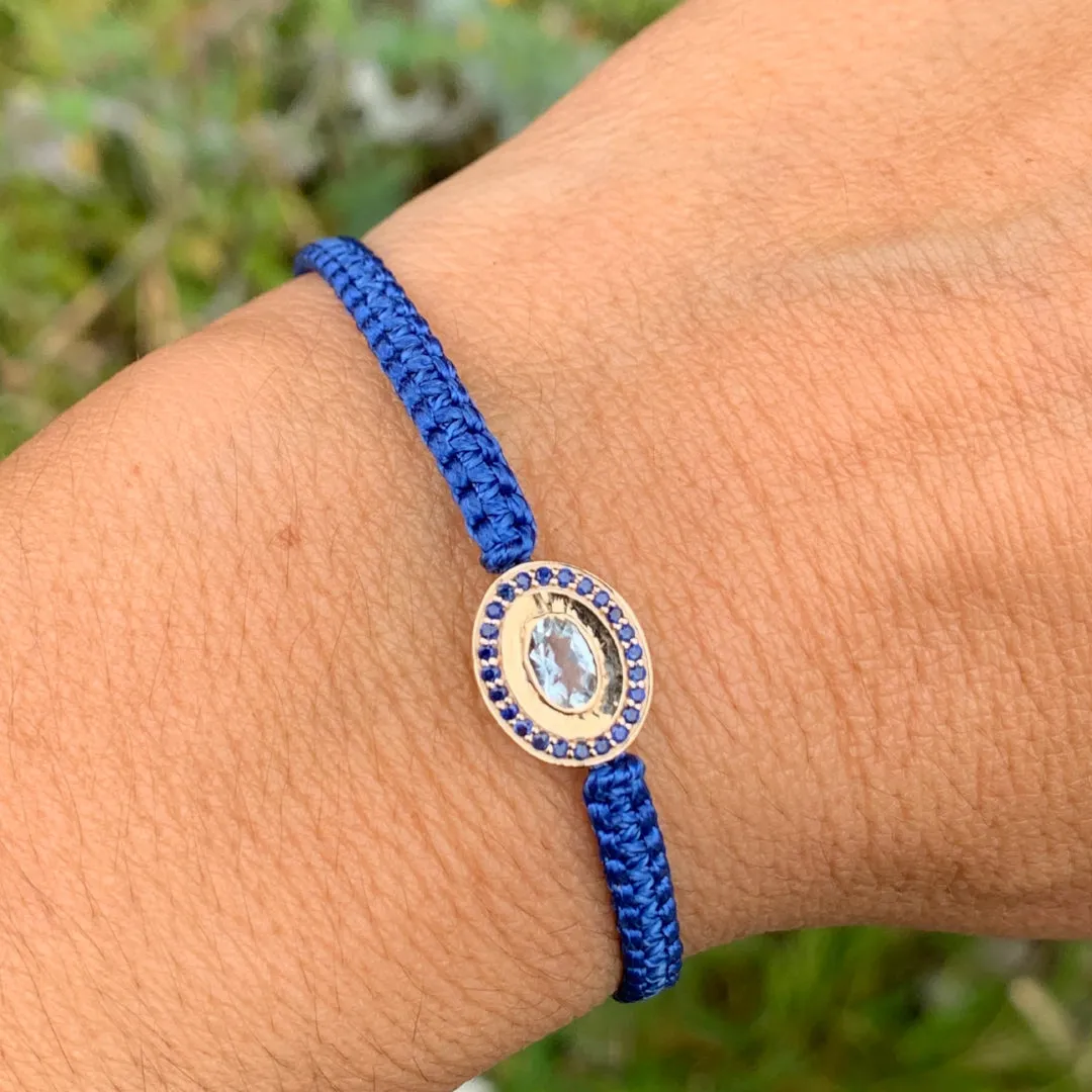 Aquamarine and Blue Sapphire braided bracelet in 10k yellow gold.